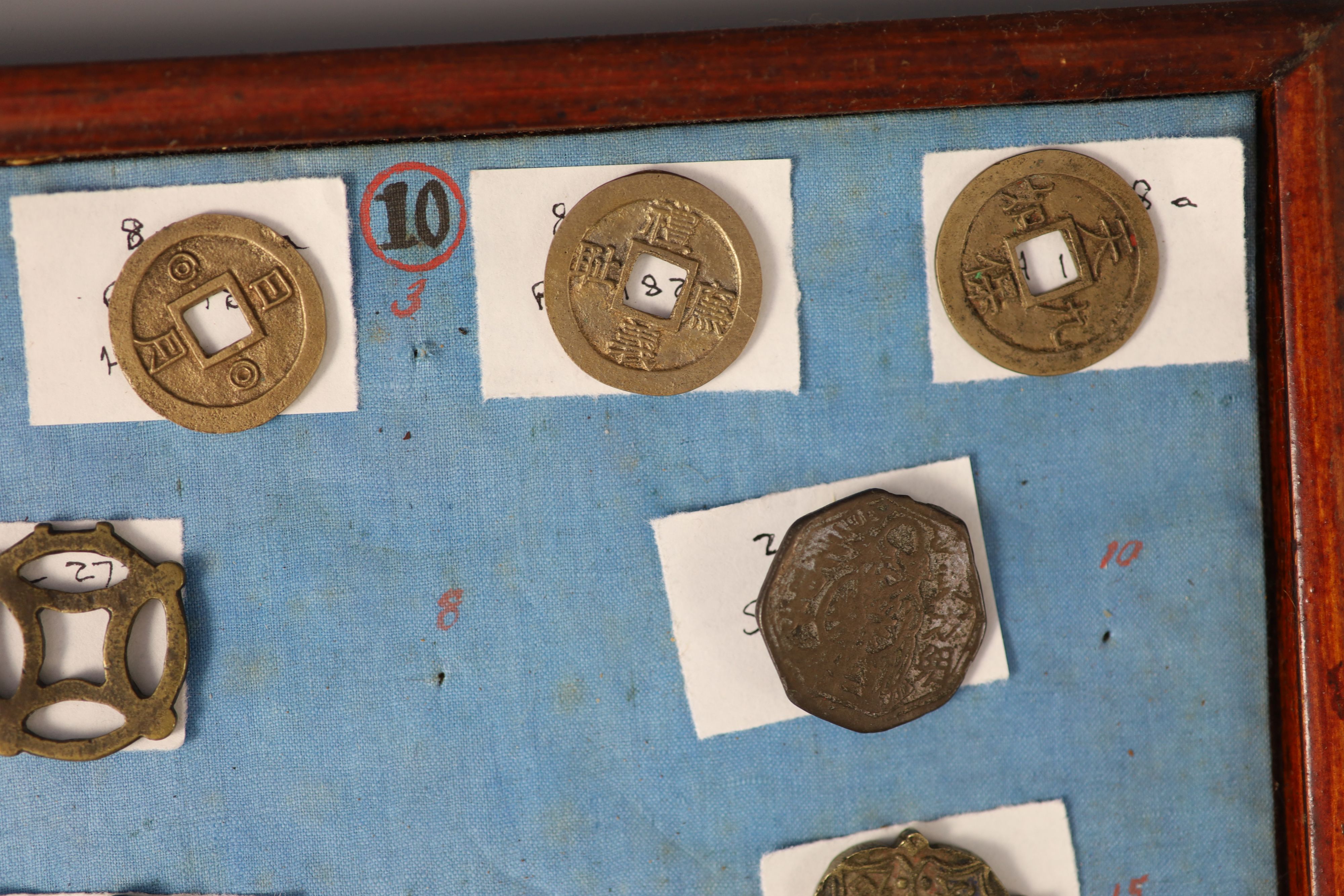 A group of 99 Korean bronze and metal amulets or charms, 19th/20th century
